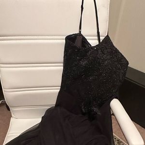 Floor length gown. Sequined top with flowy and sheer skirt.